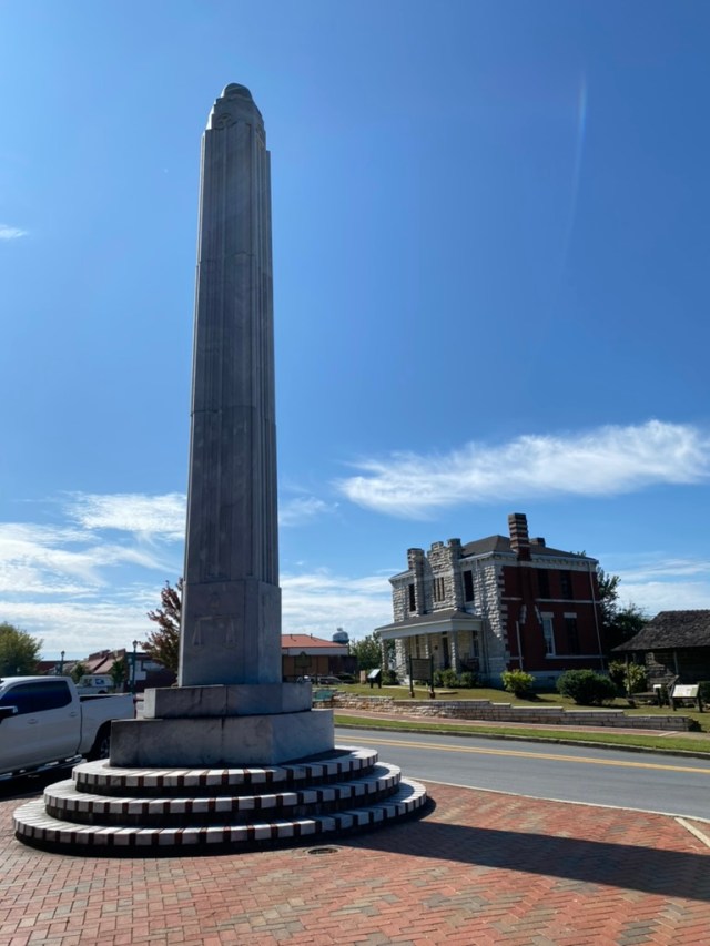The Oglethorpe Monument in Jasper, Ga., with the historic Pickens County jail in the background.
